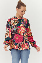 multicolor floral print blouse with ruffle neckline, puff sleeves, and flowy fit