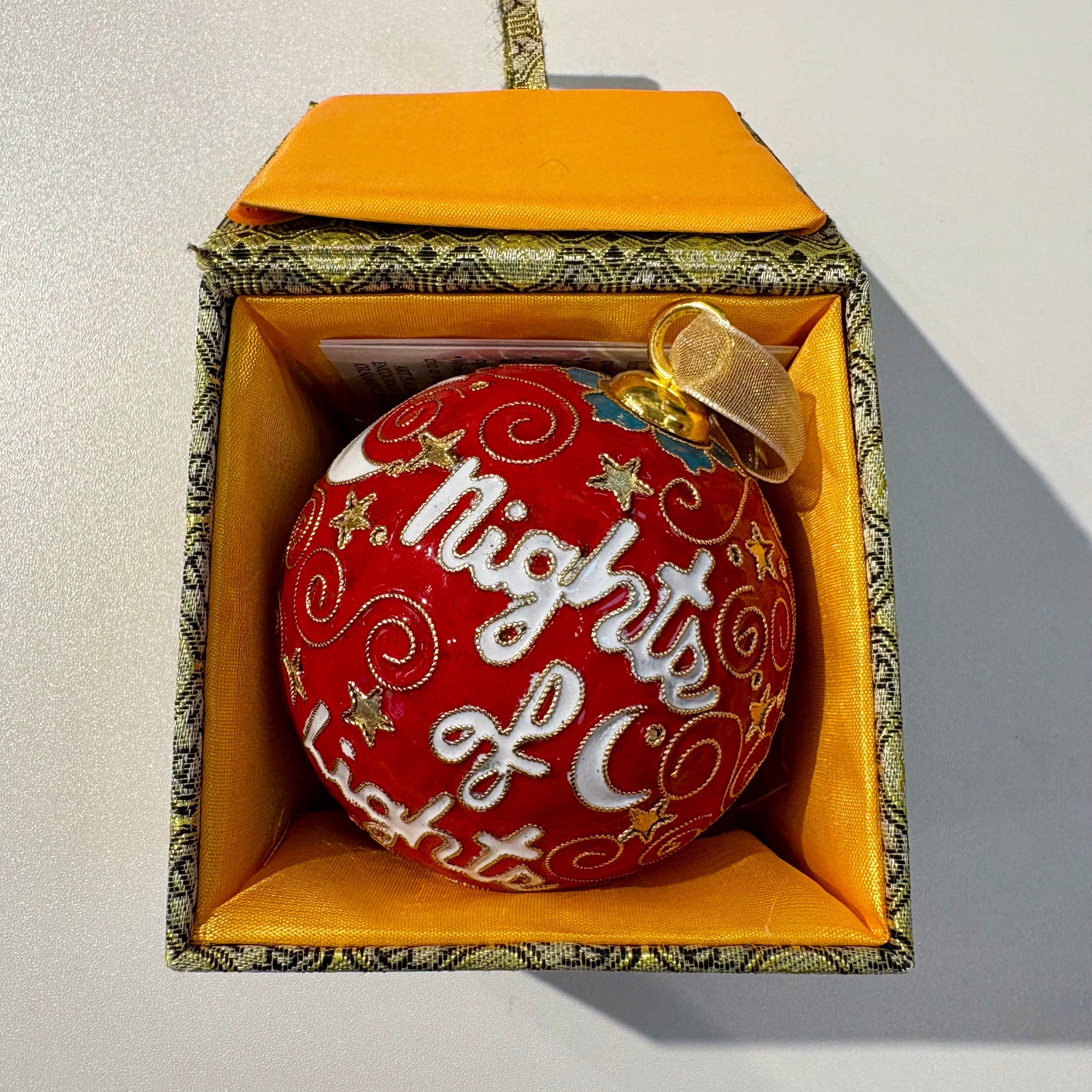 Decorative ornament with 'Nights of Lights' text in a decorative box on a light background