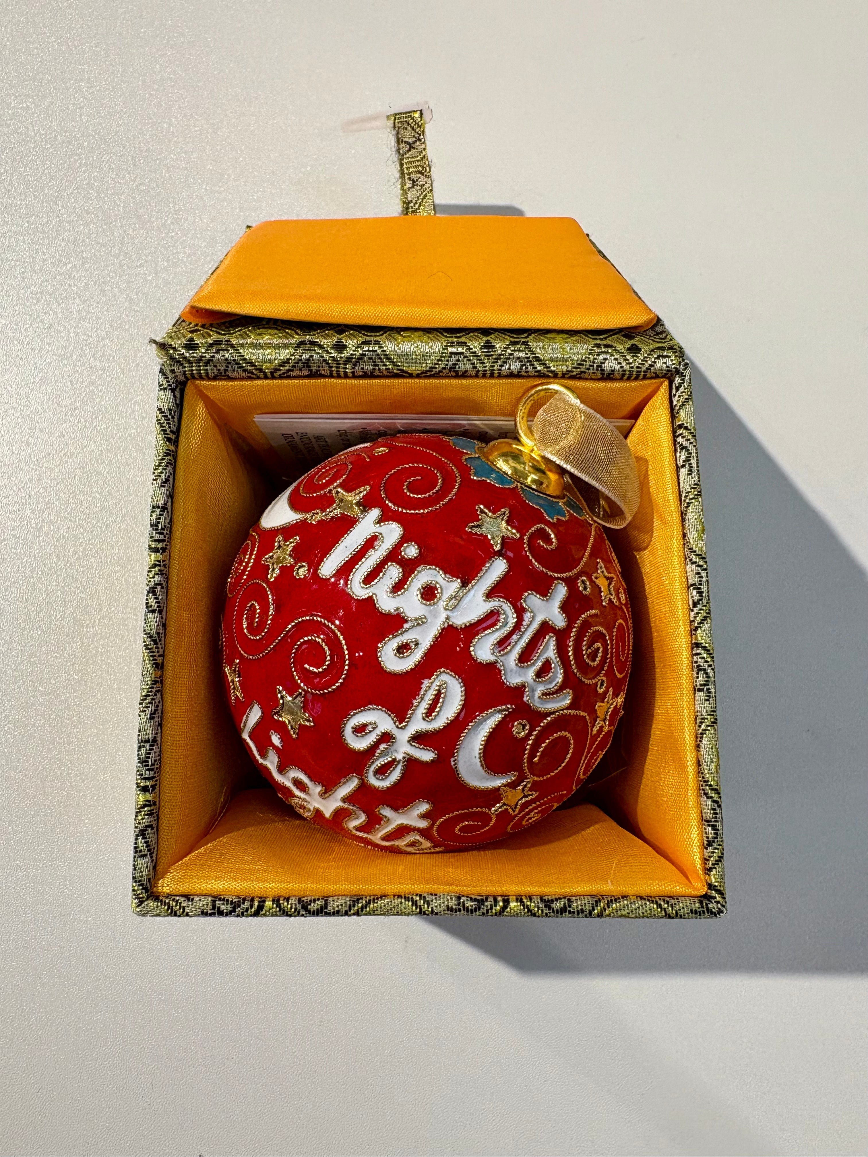 Decorative ornament with 'Nights of Lights' text in a decorative box on a light background