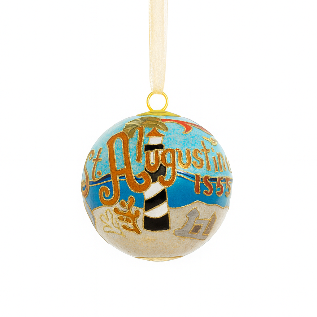 Cloisonné glass ornament featuring St. Augustine landmarks, palm trees, coastal scenery, and gold enamel details with a gold ribbon, shown on a clean white background.