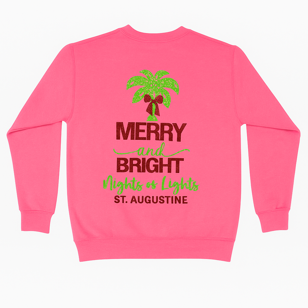 Bright pink sweatshirt with glittery red and green “Merry & Bright Nights of Lights St. Augustine” design and palm tree with bow.