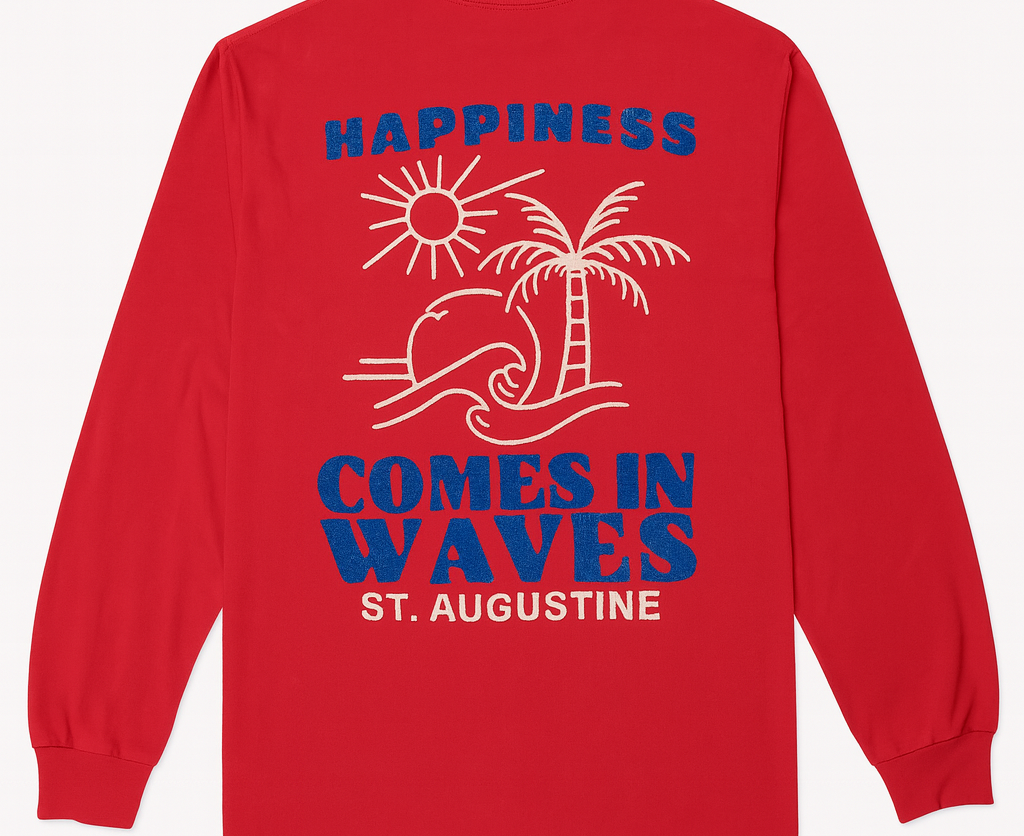 Red long sleeve cotton tee with plain decal featuring “Happiness Comes in Waves” slogan, sun, palm tree, and wave design, custom St. Augustine shirt.