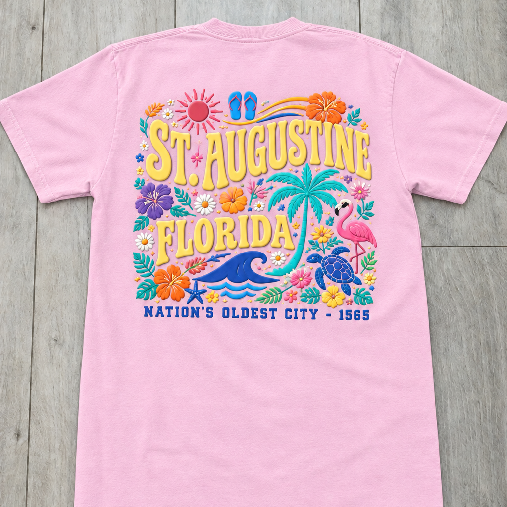 Back of lavender St. Augustine Florida t-shirt with colorful tropical floral design, palm tree, sea turtle, and “Nation’s Oldest City - 1565” text.