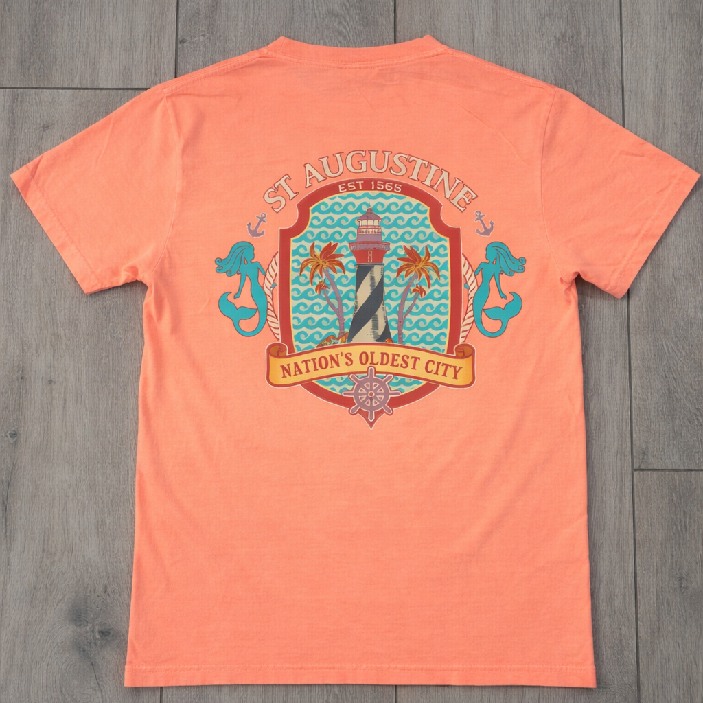 Coral St. Augustine graphic tee featuring a lighthouse, mermaids, and “Nation’s Oldest City” coastal design. A fun Florida souvenir shirt. Available at www.artsyabode.com
or in store at Artsy Abode located in historic downtown St Augustine.