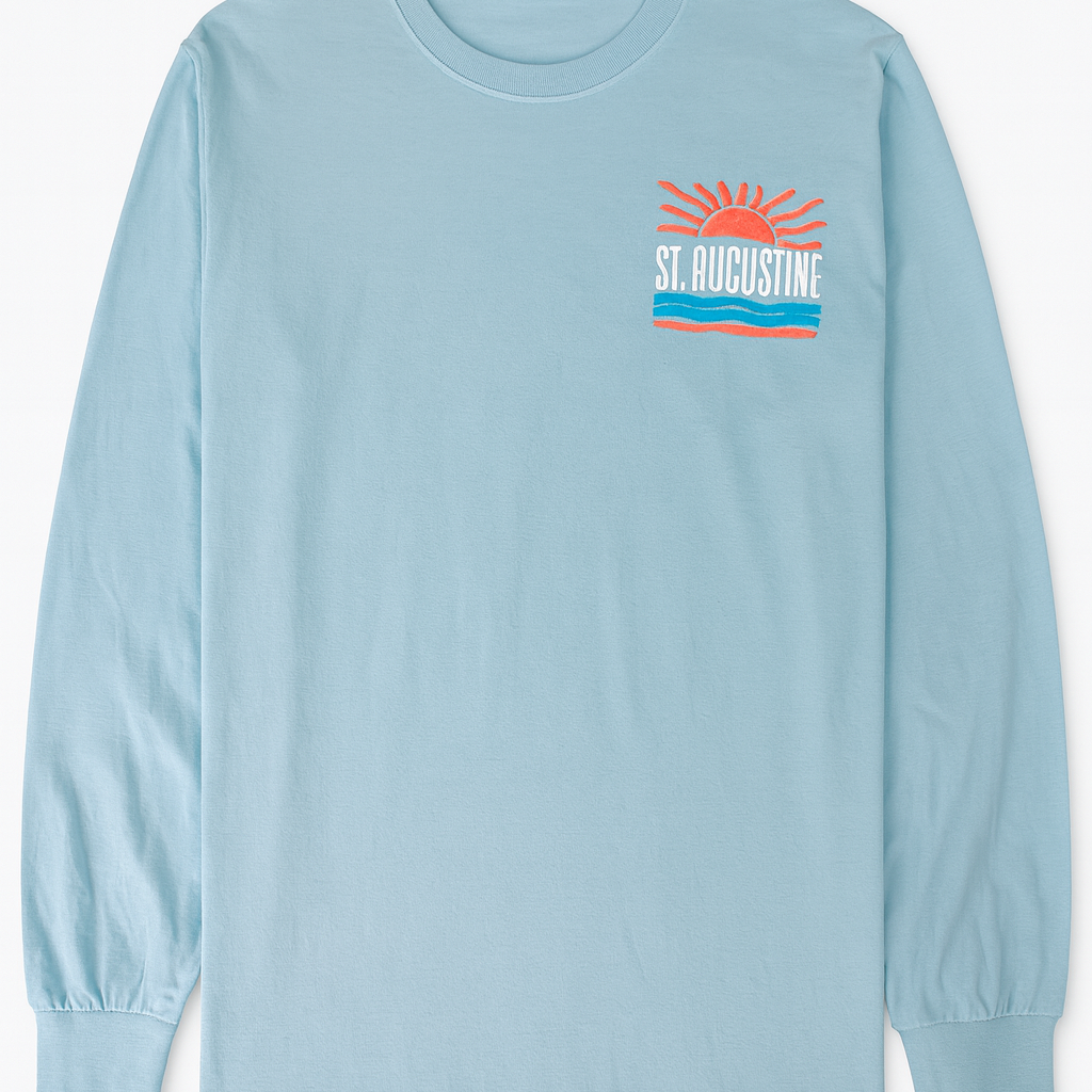 Light blue cotton long sleeve shirt with raised puffy decal design featuring a sunrise, waves, and bold St. Augustine Florida text.
