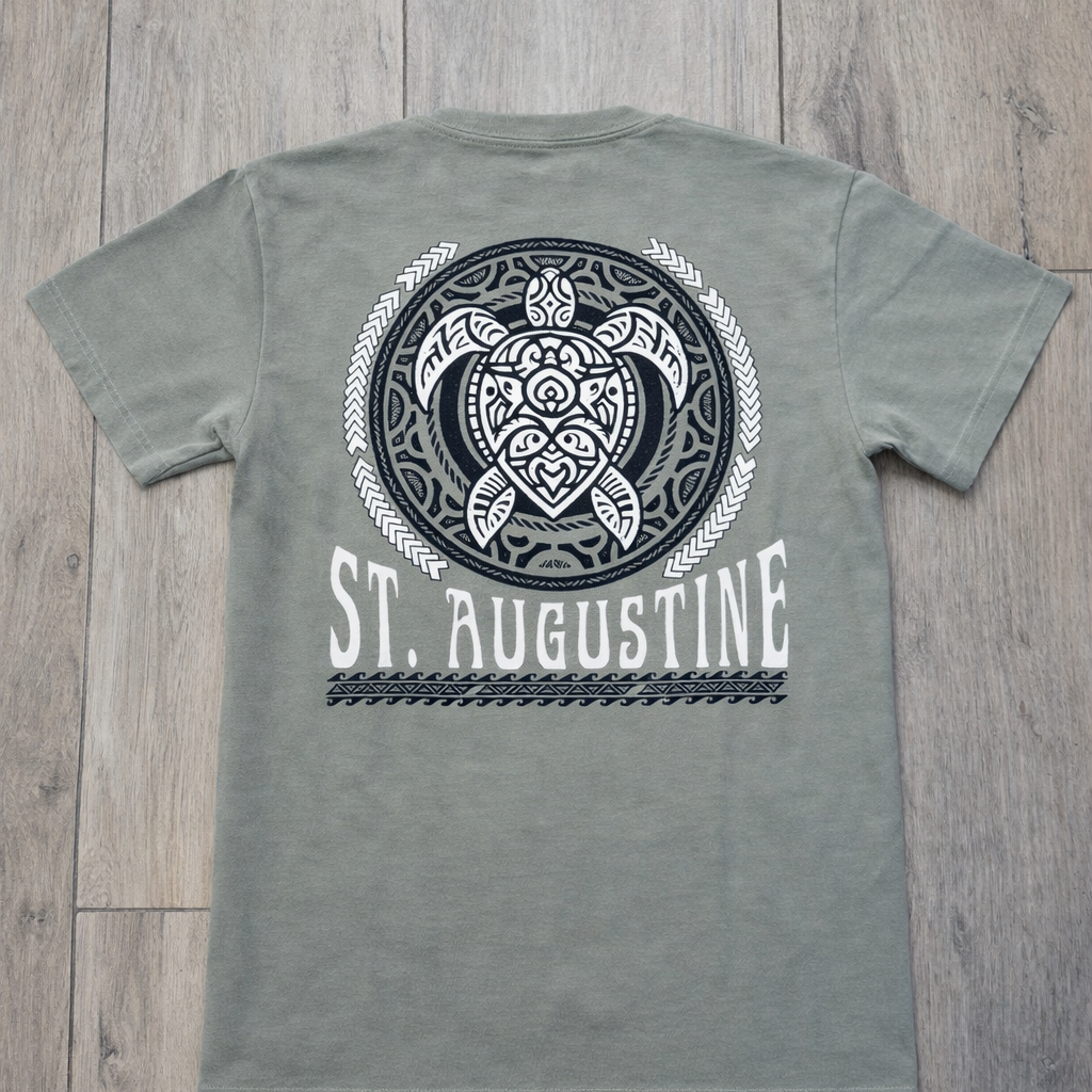 Back of sage green St. Augustine t-shirt with large tribal-style sea turtle graphic and bold white St. Augustine text.