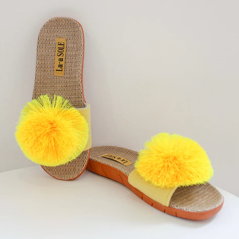 Yellow Pom Pom Slide Sandals with cheerful pom pom and woven textured sole