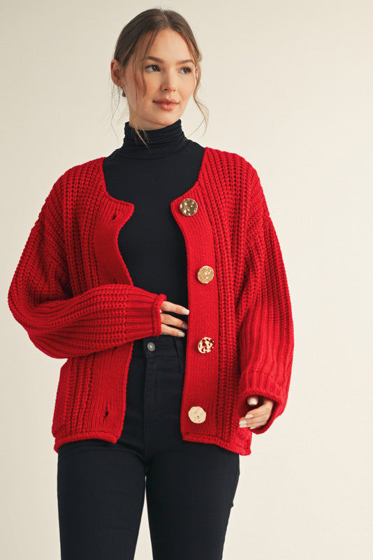 Woman wearing a red cardigan with gold buttons on a beige background