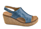 Ocean blue wedge sandal with an open toe, slingback strap, cushioned tan footbed, and raffia-inspired platform wedge.