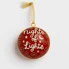 Red cloisonné glass ornament with gold swirls, stars, moon, and “Nights of Lights” script, accented with a gold ribbon, photographed on a clean white background.