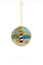 Cloisonné glass ornament featuring St. Augustine landmarks, palm trees, coastal scenery, and gold enamel details with a gold ribbon, shown on a clean white background.