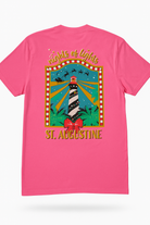 Bright pink short sleeve tee with St. Augustine lighthouse and “Nights of Lights” holiday design in gold and red accents.