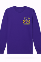 Purple long sleeve cotton tee featuring small “Nights of Lights St. Augustine” lighthouse and sunburst design on the left chest.