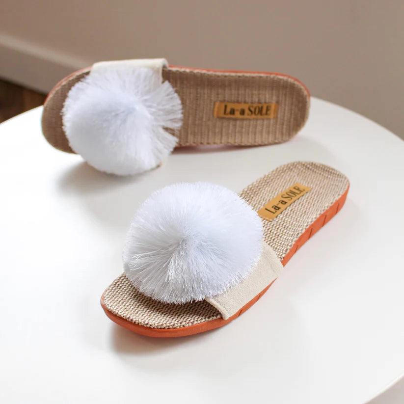 White Pom Pom Slide Sandals with oversized pom pom detail on woven sole