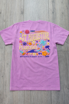 Back of lavender St. Augustine Florida t-shirt with colorful tropical floral design, palm tree, sea turtle, and “Nation’s Oldest City - 1565” text.