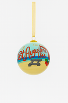 Hand-painted glass Christmas ornament with “St. Augustine 1565” lettering, beach scene artwork, and gold hanging ribbon photographed on a clean white background.