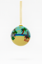 Decorative beach-themed ornament with palm trees and 'Relax' text on a white background