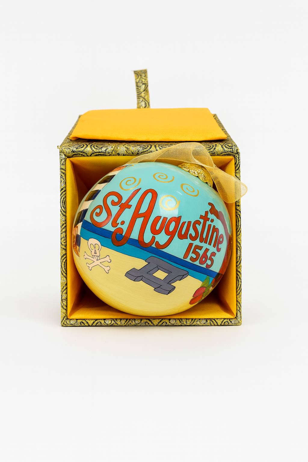 Hand-painted glass Christmas ornament with “St. Augustine 1565” lettering, beach scene artwork, and gold hanging ribbon photographed on a clean white background.