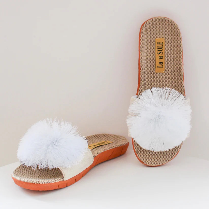 White Pom Pom Slide Sandals with oversized pom pom detail on woven sole