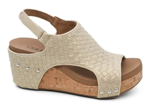 Natural woven platform slingback sandal with open toe, cork wedge sole, cushioned footbed, and metallic stud accents on a white background.