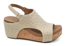 Natural woven platform slingback sandal with open toe, cork wedge sole, cushioned footbed, and metallic stud accents on a white background.